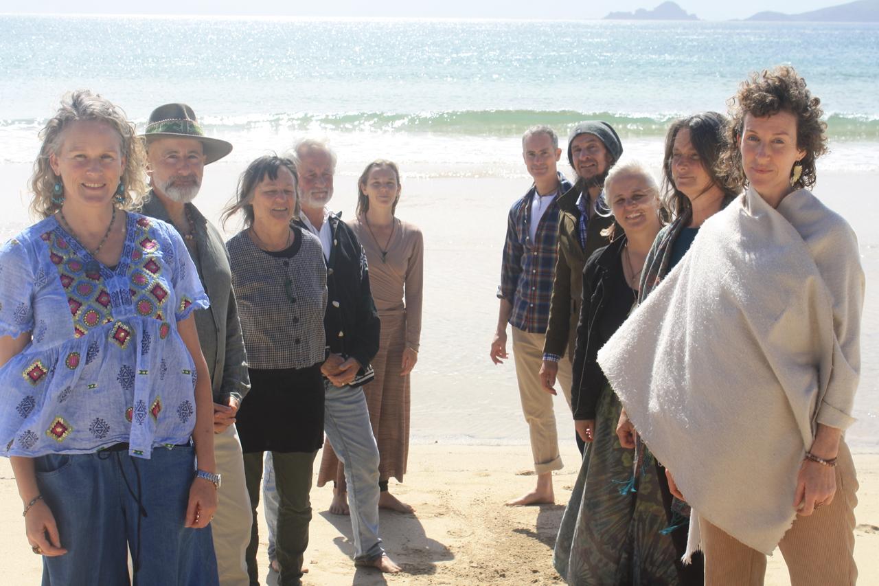 The Empathy Angels team standing together on a beach in Kaitaia, New Zealand