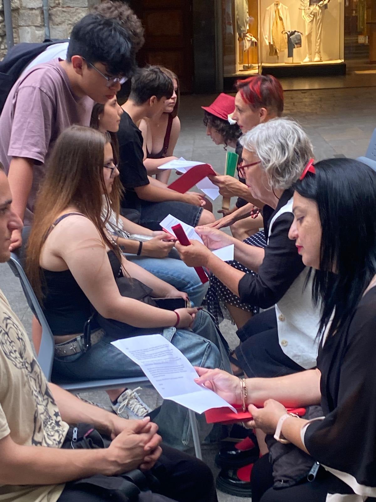 Participants sitting face to face, reading written words to one another